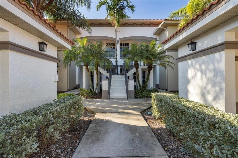 Doorway to property featuring a tile roof and stucco siding