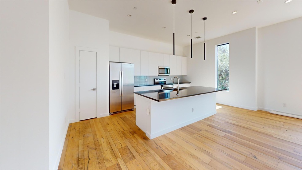 Kitchen with an island with sink, light wood-type 