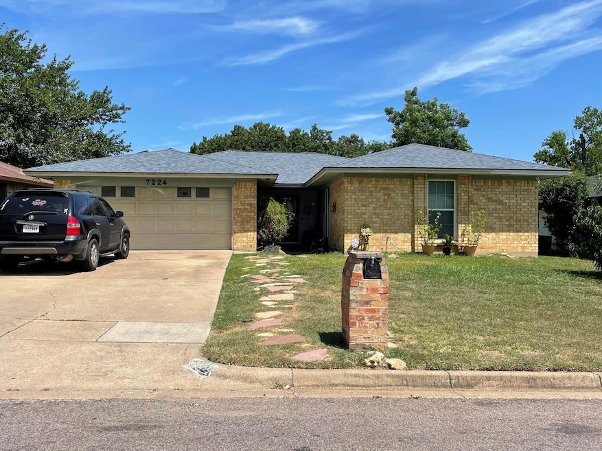 View of front of property featuring a garage and a