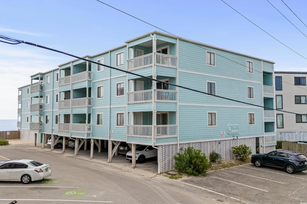 View of property featuring uncovered parking