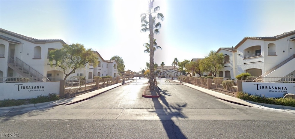 View of asphalt road with a residential view, curb