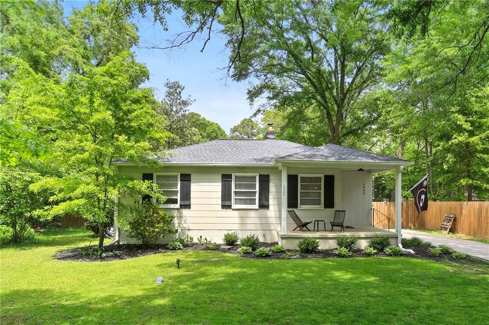 View of front of property featuring fence, a porch