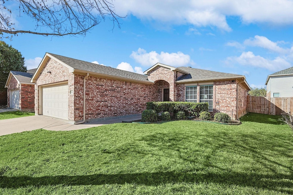 Single story home featuring a garage and a front l
