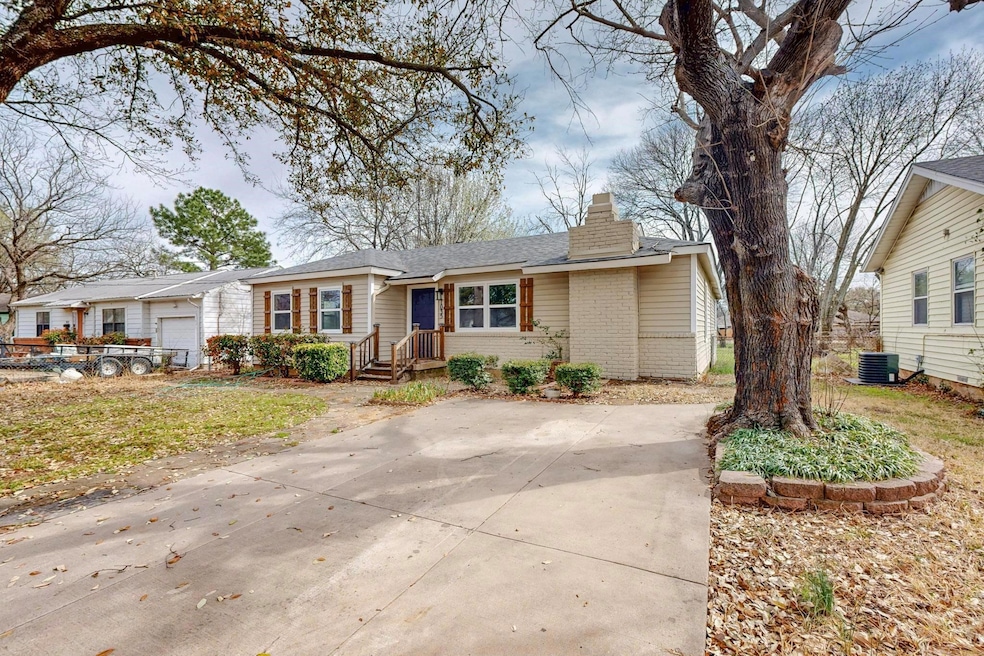 Ranch-style house with an attached garage, a chimn