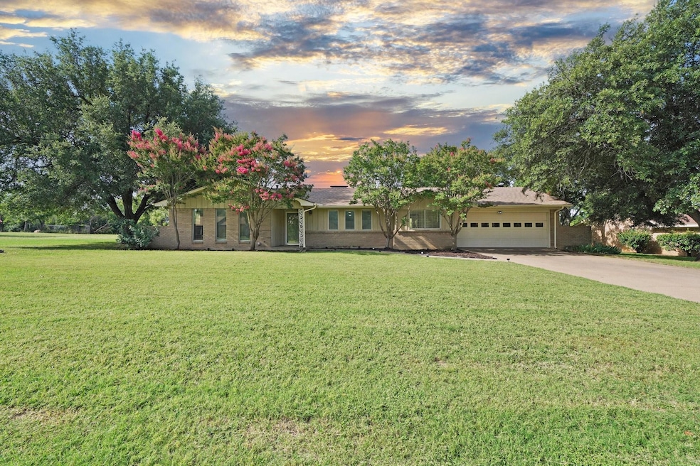 Ranch-style home with a yard and a garage