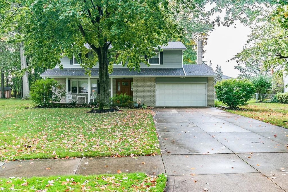 Front facade with a front lawn, a garage, and cove