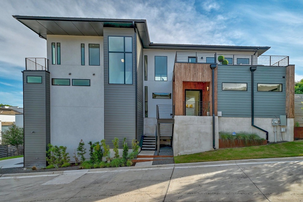 View of front of property with a balcony and stuc