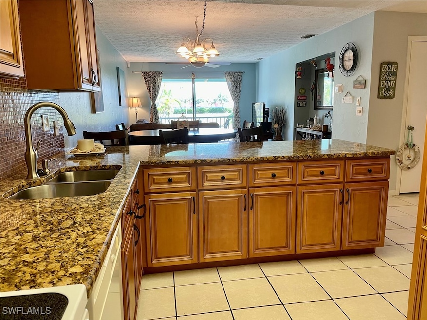 Beautiful kitchen with granite + glass tile