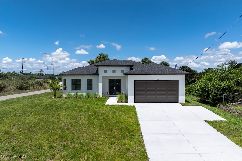 Prairie-style home featuring stucco siding, a gara