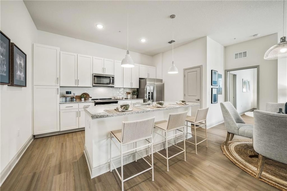Kitchen with stainless steel appliances, white cab