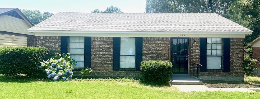 View of front of home featuring a shingled roof and a front lawn