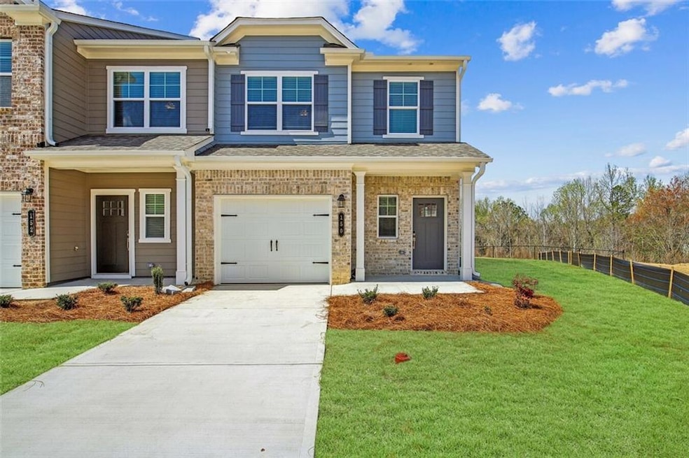 View of front of home with a garage and a front ya