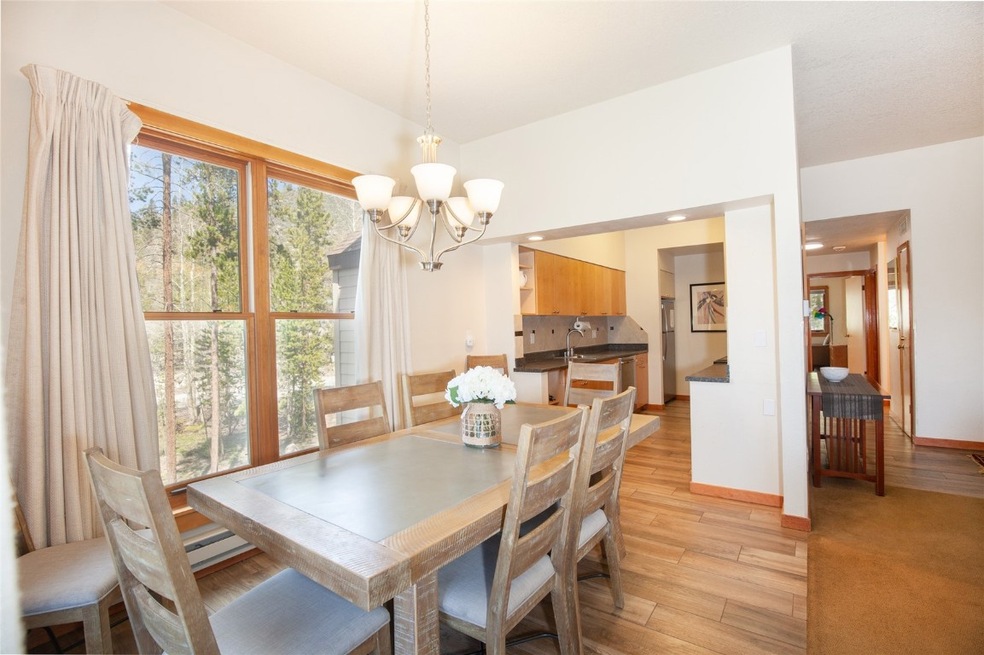 Dining space with hardwood / wood-style floors and