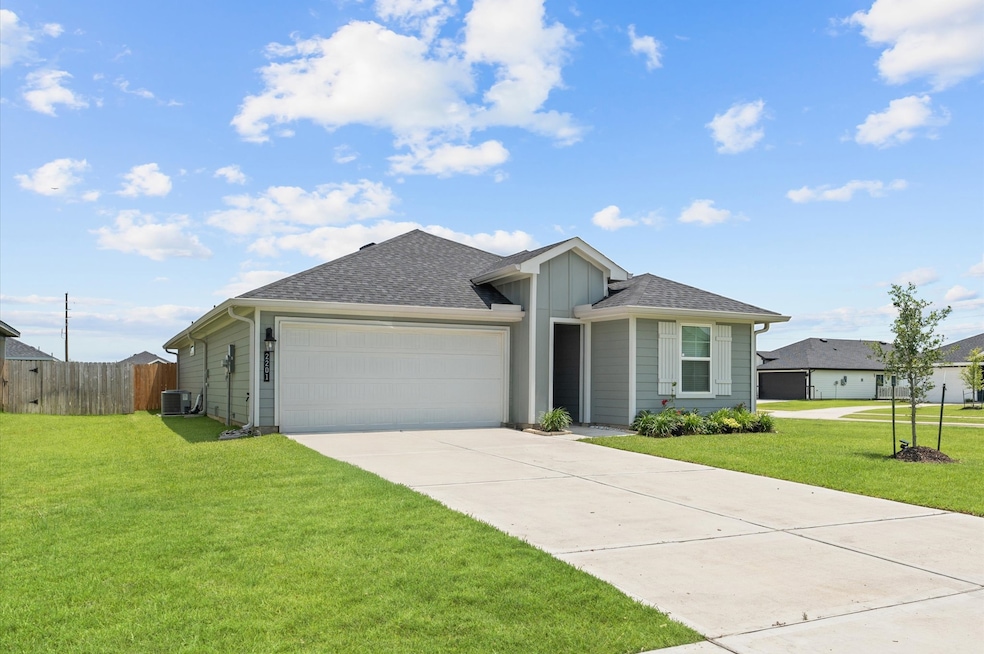 Home features spacious driveway leading to the dou