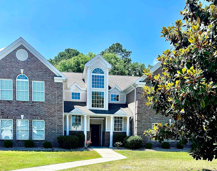 View of front of property with a front lawn, roof 