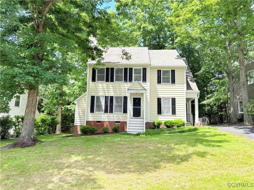 Colonial-style house with entry steps, a chimney,