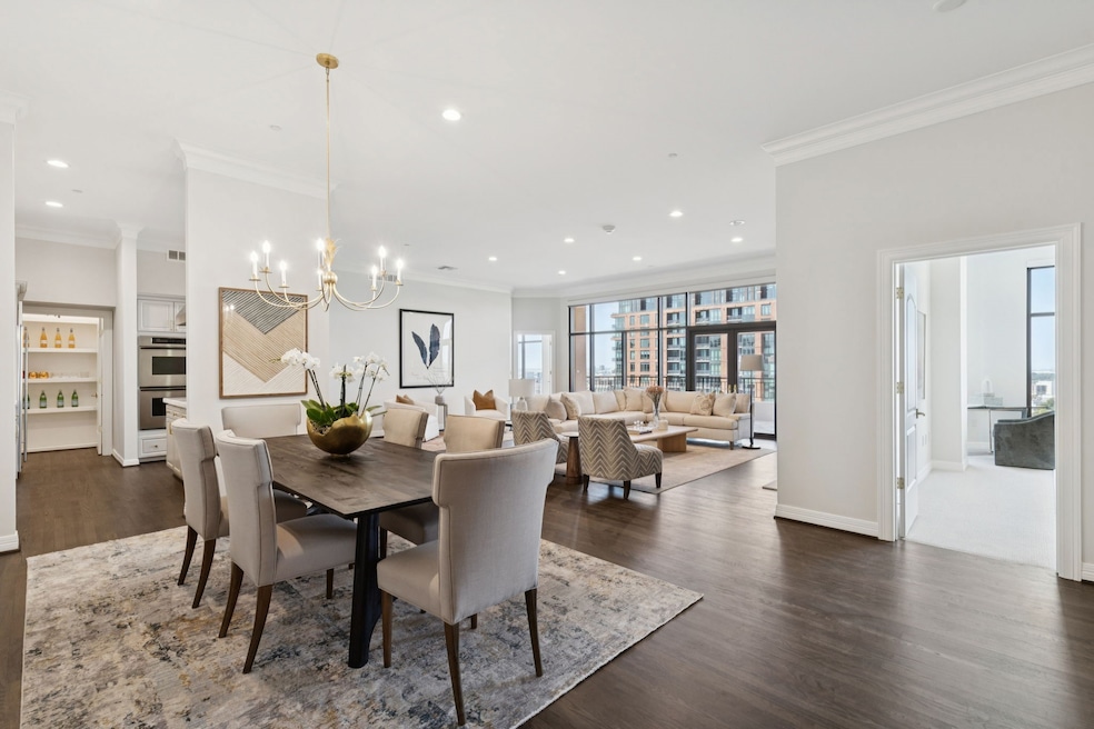 Dining area featuring ornamental molding, recessed lighting, dark wood-type flooring, and a chandelier