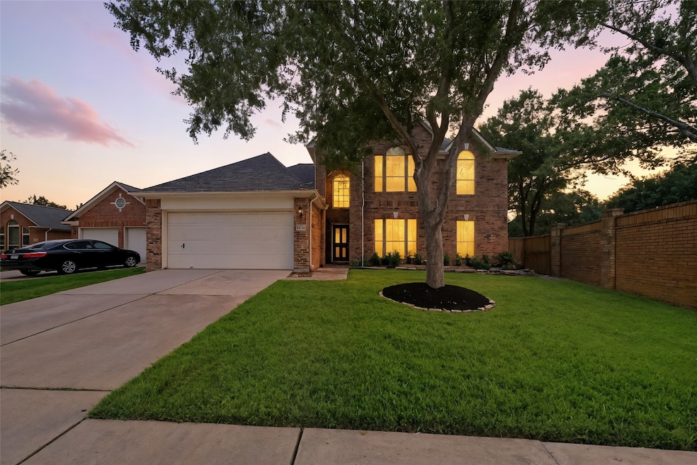 This home showcases a charming two-story brick hom