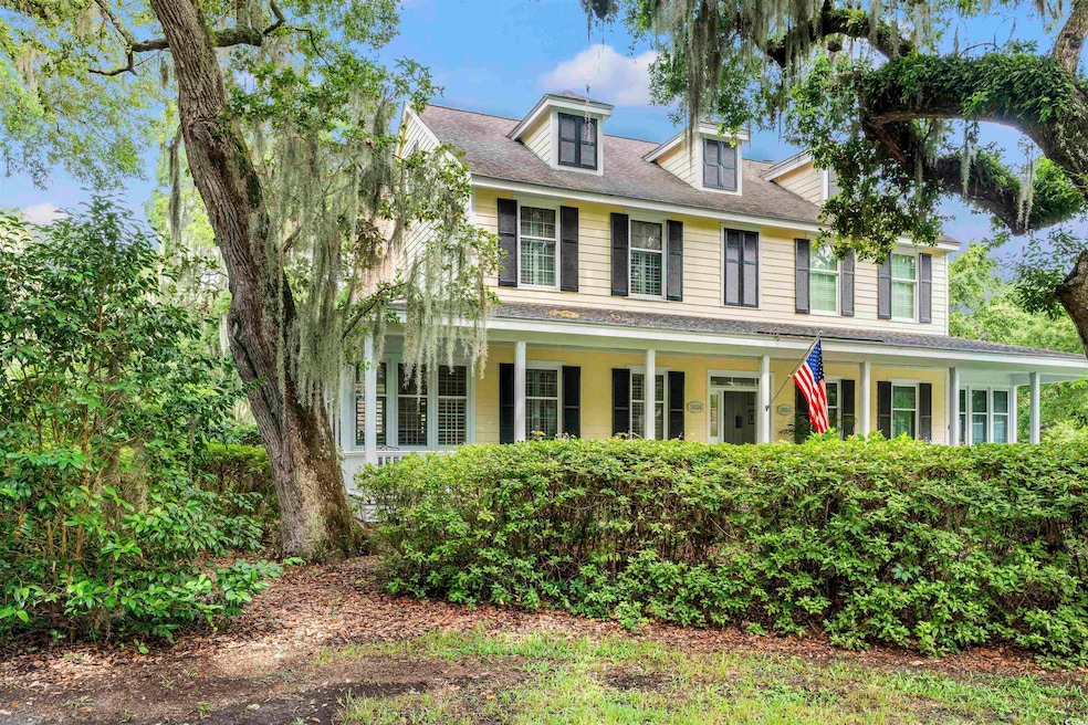 View of front of home featuring a shingled roof and covered porch