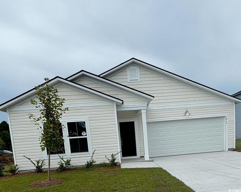 View of front of property featuring a garage and a