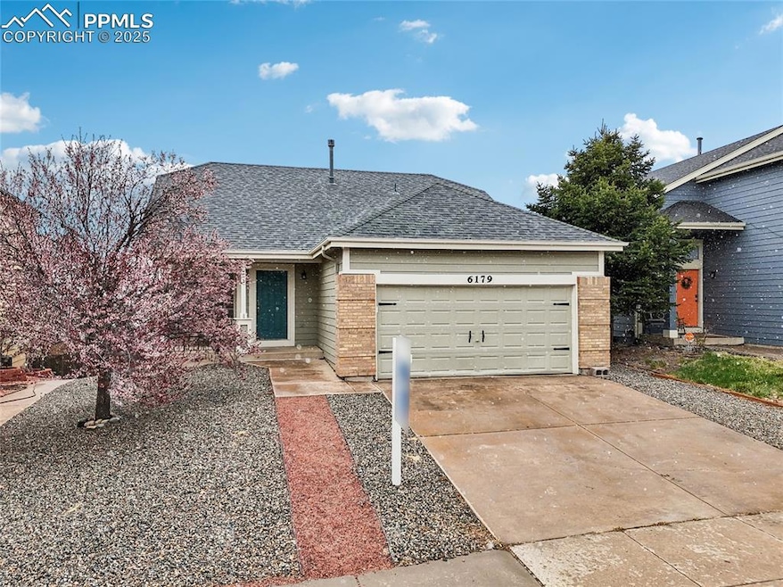 Ranch-style house with driveway, roof with shingles, and a garage
