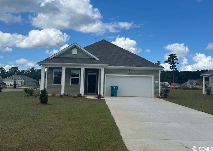 View of front of home with a garage and a front la