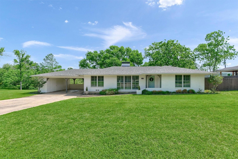 Ranch-style home featuring a Beautiful lawn and a Double carport