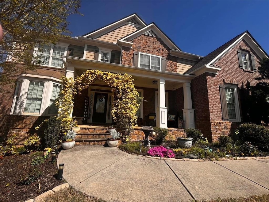 Home featuring stone and brick siding with covered porch