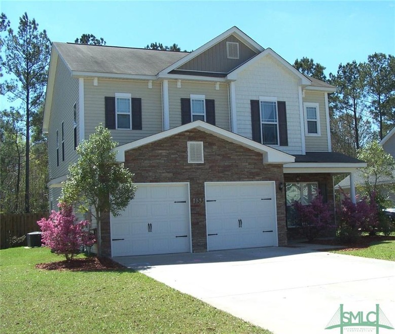Front view of home with stone accent at garage and