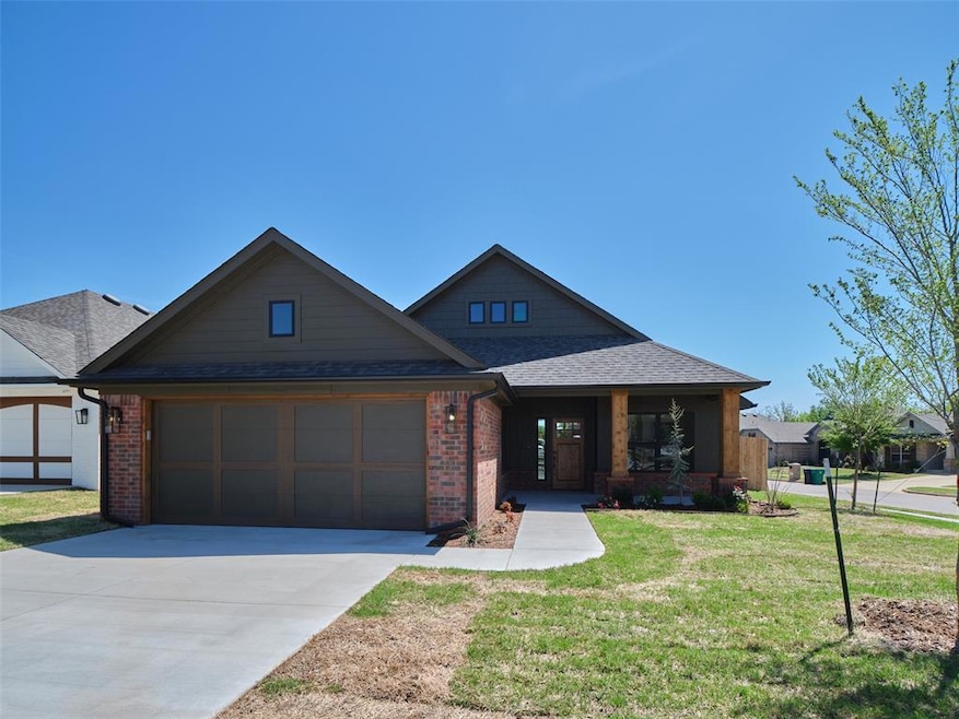 Craftsman-style house with brick siding, concrete 