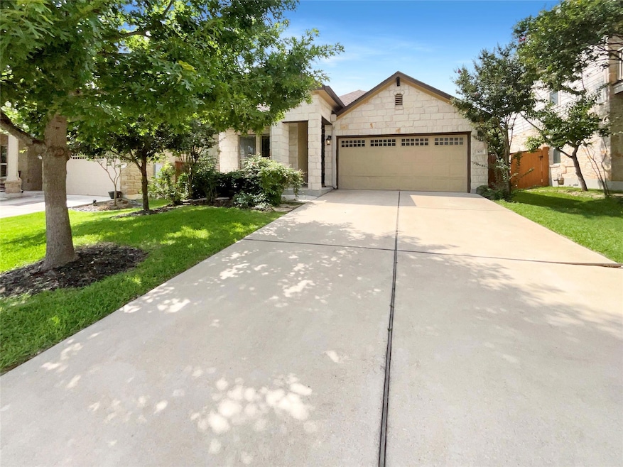 View of front of property with a garage, driveway