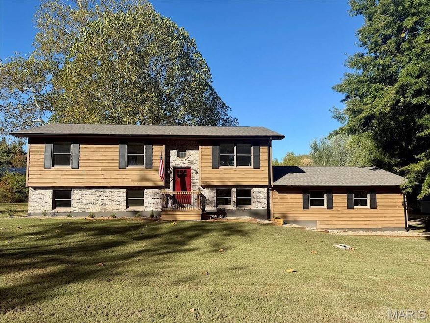 Split foyer home with a front lawn