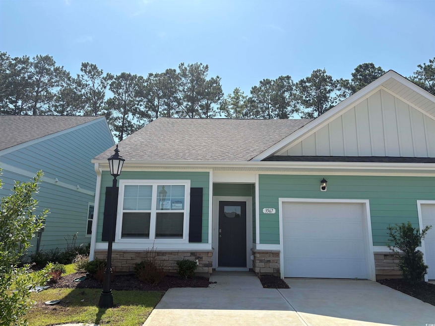 Craftsman house featuring board and batten siding, an attached garage, roof with shingles, and concrete driveway
