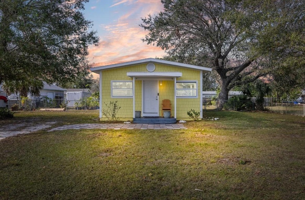 Front view of home featuring large oak trees.