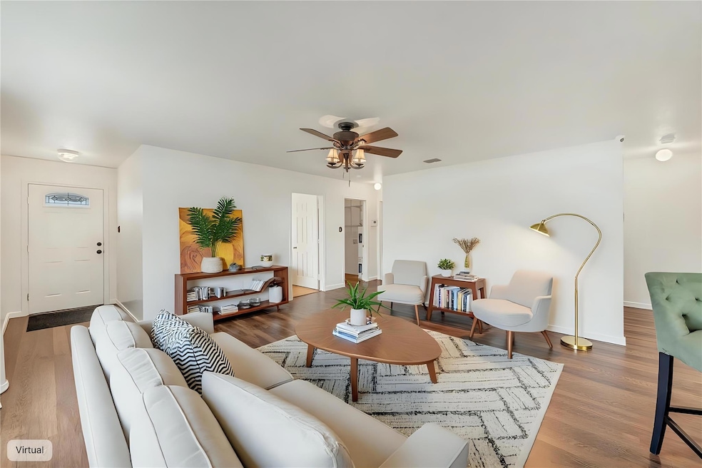 Living area featuring wood finished floors, a cei