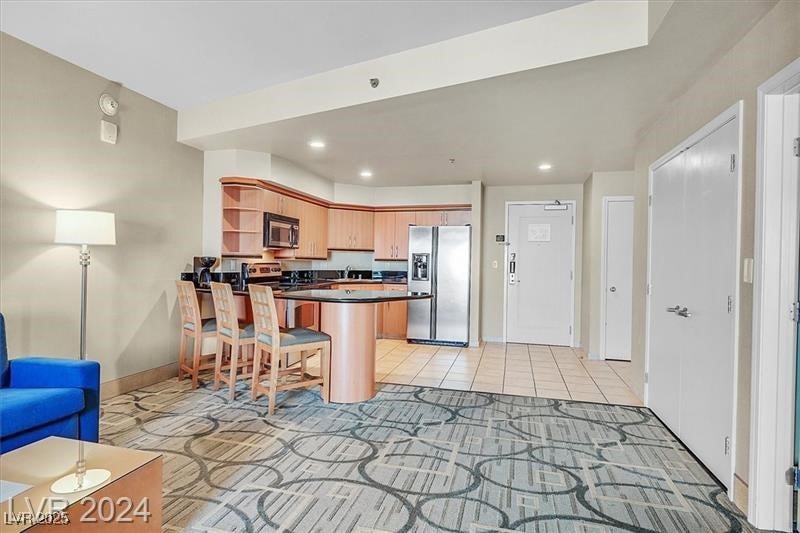 Kitchen with recessed lighting, a peninsula, open