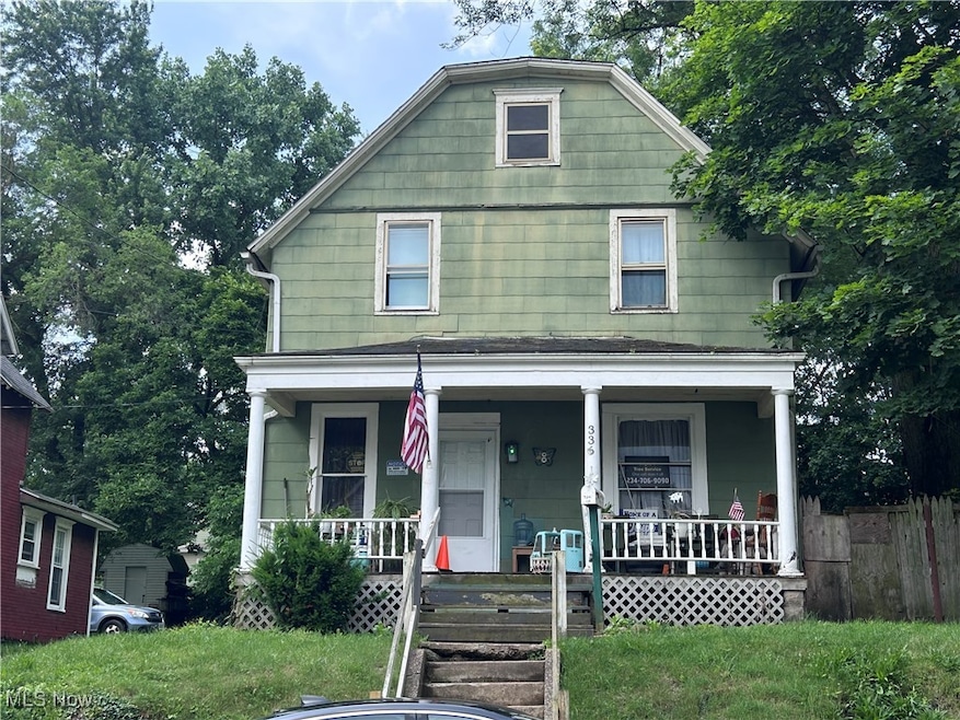 View of front facade with covered porch and a front yard