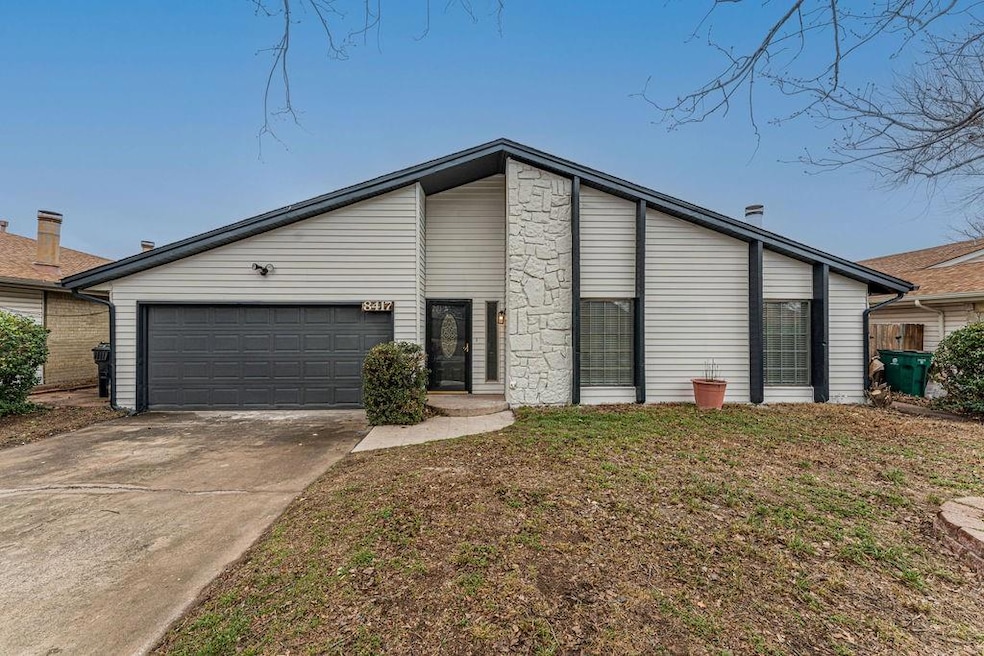 View of front of house with a garage and a front y