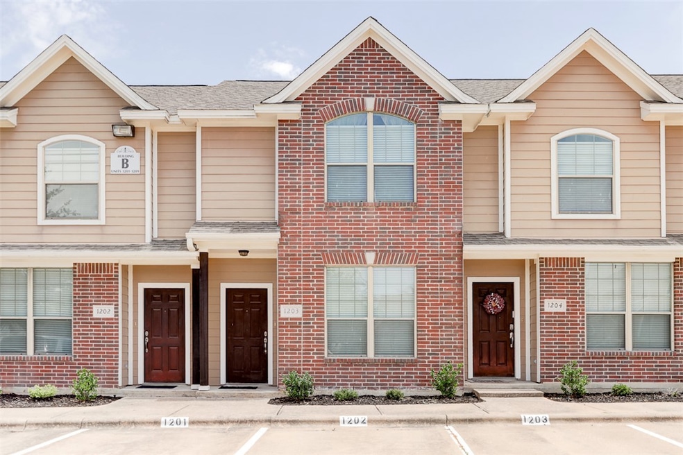 Multi unit property featuring brick siding, uncove