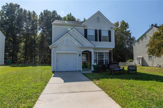 Exterior with long driveway and partial brick fron
