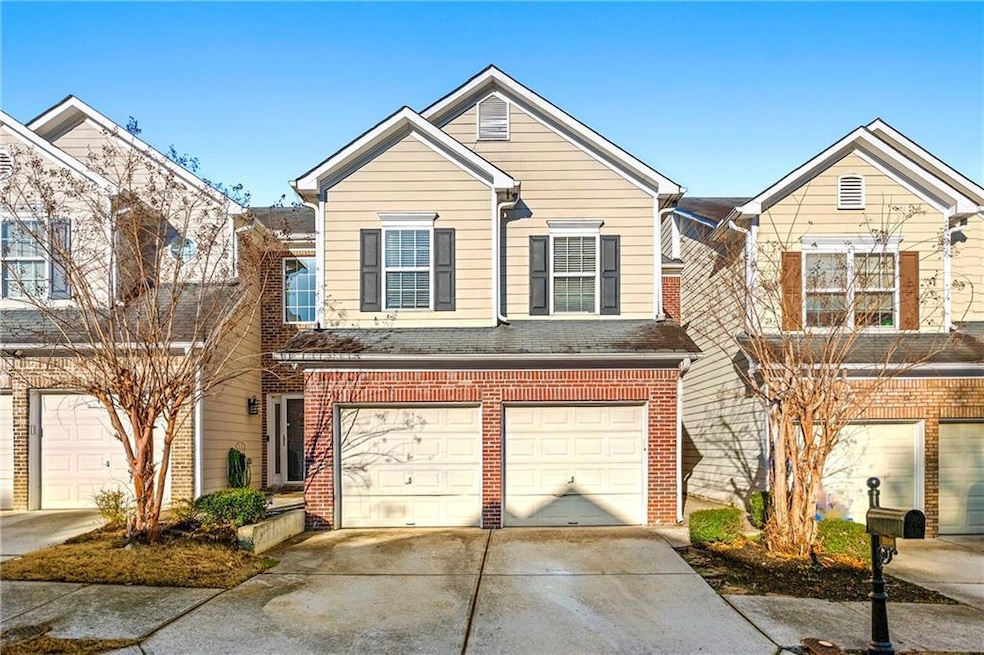 Traditional-style home featuring driveway, brick s