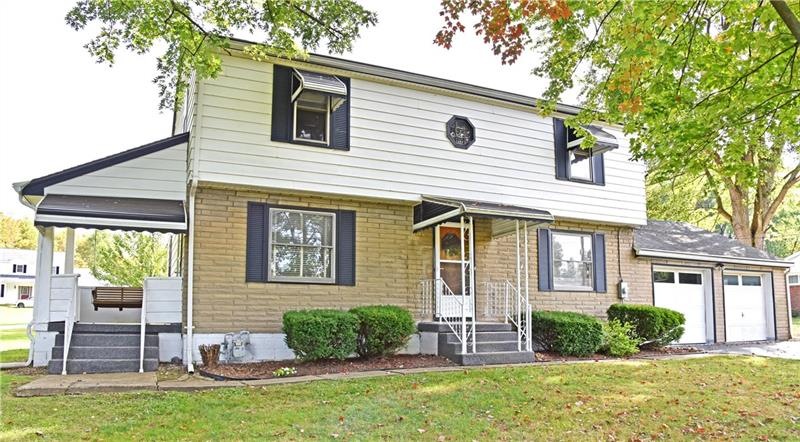 The two story home is situated on a large lot, wit