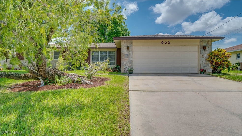 Ranch-style home with a front yard and a garage
