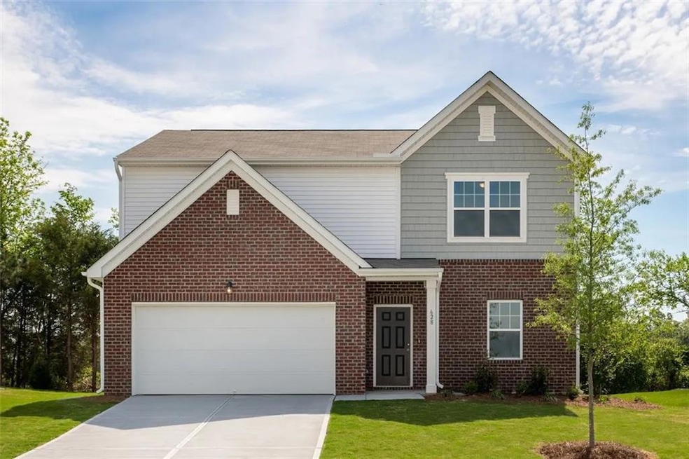 View of front facade with a garage and a front law