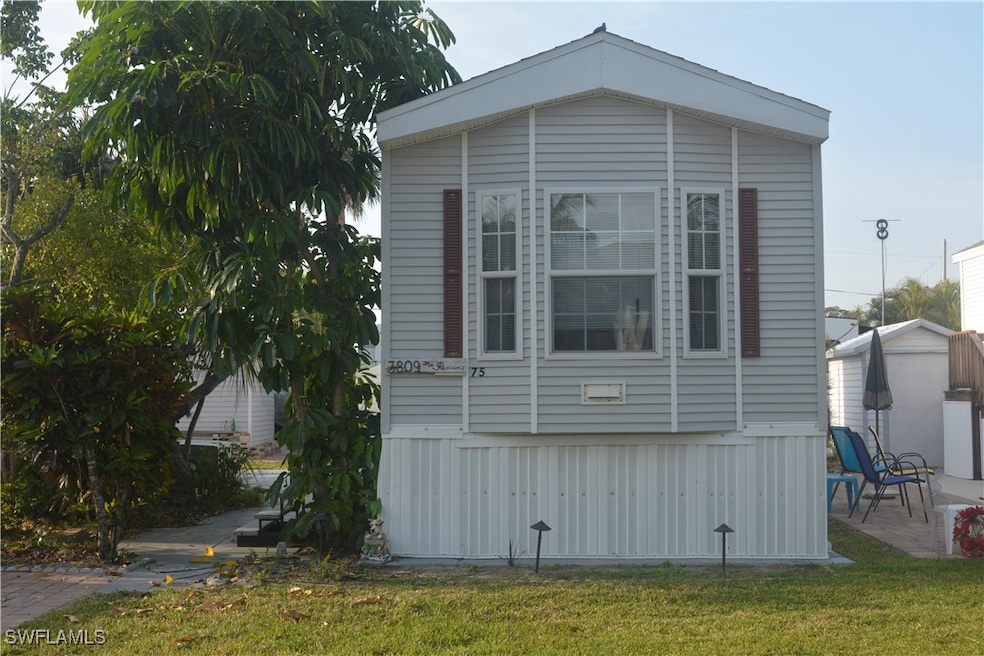 View of home's exterior featuring a lawn and a pat