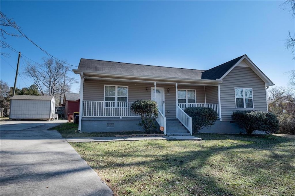 Ranch-style home with a storage shed, covered porc