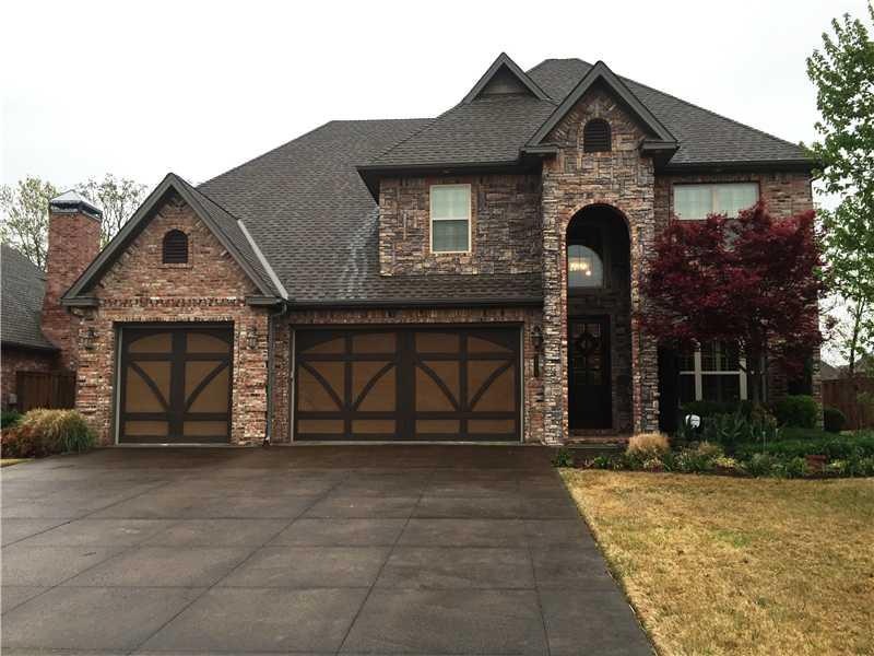 Facade/Exterior Front. Stained concrete drive, used brick with dry stack stone.
