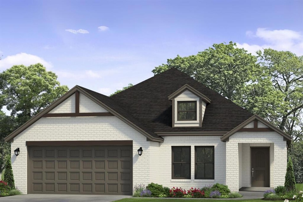 View of front of home featuring brick siding, an attached garage, and driveway
