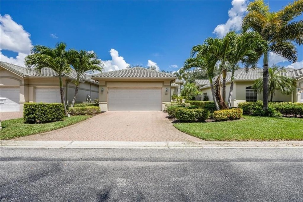 Ranch-style house featuring decorative driveway, stucco siding, a garage, a tile roof, and a front yard