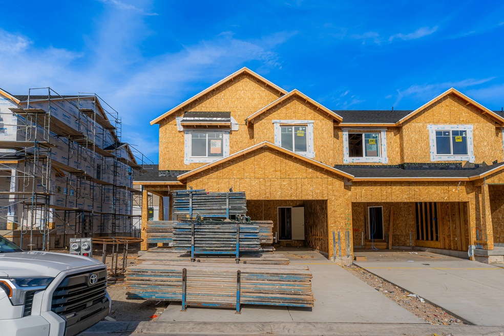 View of front facade featuring a shingled roof and a porch